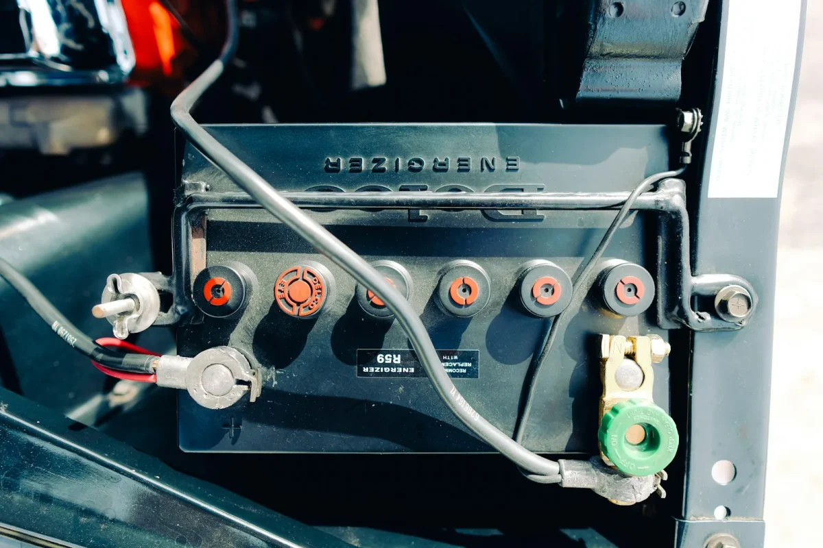 Corrosion buildup on a UTV battery terminal and cable clamp