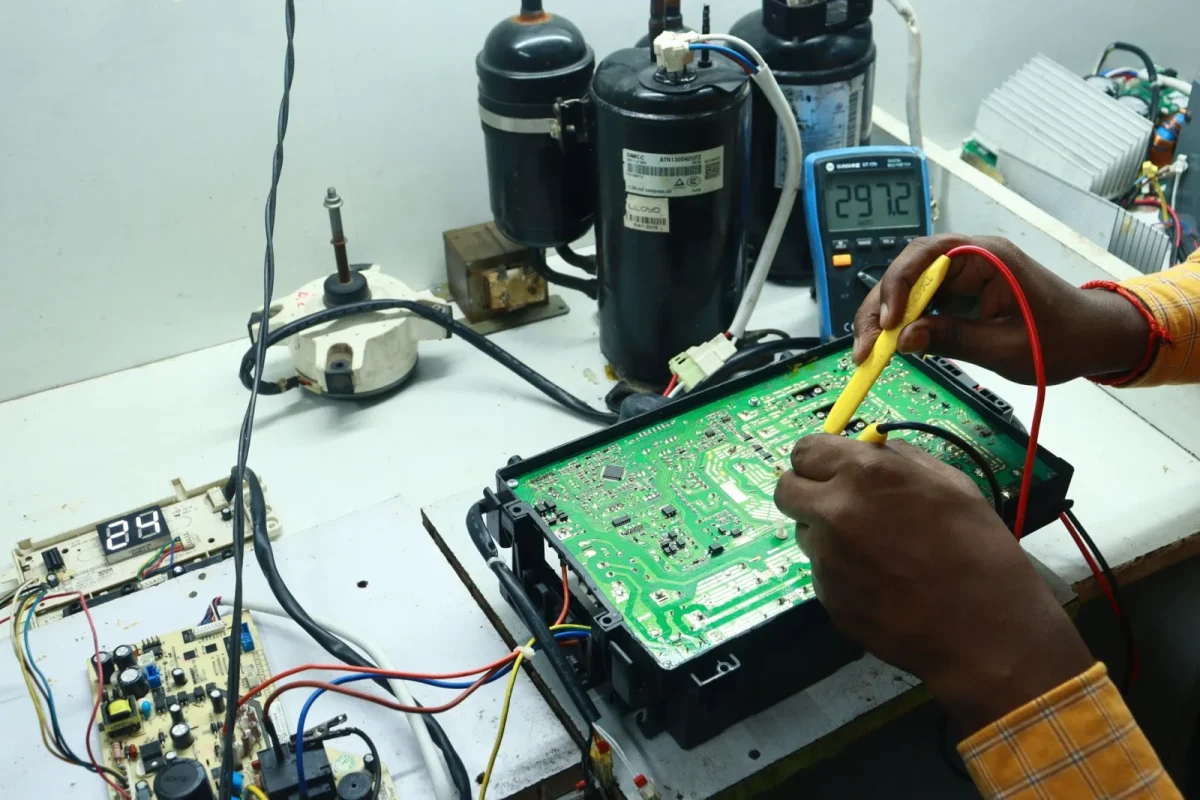 Multimeter clipped to a UTV battery showing a charging voltage reading